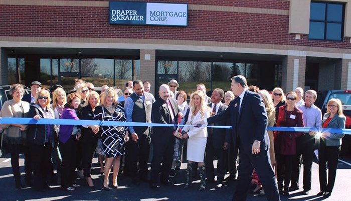 Quin Bernhardt, branch manager and Deena Sisson, regional vice president, cut the ribbon for Draper and Kramer Mortgage Corp.’s new branch office in Louisville, Ky., during a grand opening celebration.