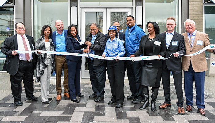 A ribbon-cutting at the City of Chicago’s first Culver’s restaurant at Draper and Kramer’s Lake Meadows Market. Pictured (left to right): Forrest Bailey, president and CEO, Draper and Kramer; Kelly Powers Baria, director of business development, Powers & Sons Construction Company; Joe Koss, president and CEO, Culver’s; Sophia King, 4th Ward alderman; Baron Waller, Culver’s franchise owner, with his wife, Janeen Waller, brother, Byron Waller, and nephew and business partner Bryon Waller; Marcia Nicholson, senior business banker, Urban Partnership Bank; Gordon Ziegenhagen, vice president, Draper and Kramer; and Craig Culver, co-founder, Culver’s.