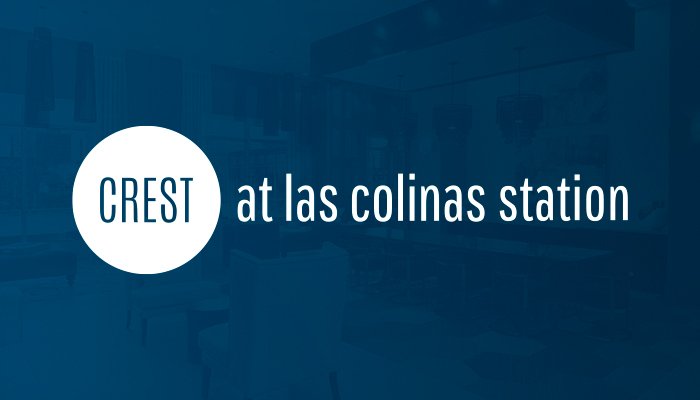 The Crest at Las Colinas Station logo presented on a blue background. The logo is horizontal with "Crest" written in a circle on the left and "at las colinas station" out to the right.