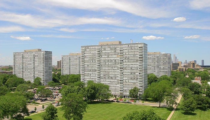 The various apartment buildings of Lake Meadows on a sunny day looking north with the Chicago skyline on the horizon.
