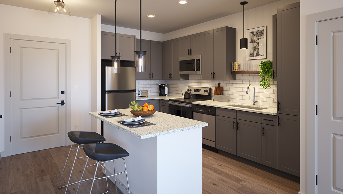 Rendering of a kitchen in a residence of Moda at The Hill. An island countertop is in the foreground with two stools next to it. Behind is the kitchen with cool gray cabinets and stainless steel appliances.