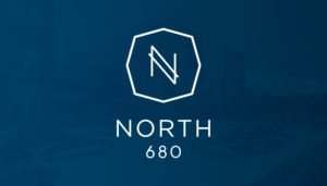 The North 680 logo presented on a blue background. The logo feature a stylized "N" in side a flattened octagon with North 680 written below it.
