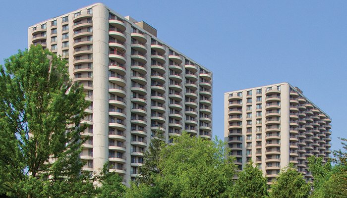 An exterior view of both towers at Wheaton Center with trees in the foreground.