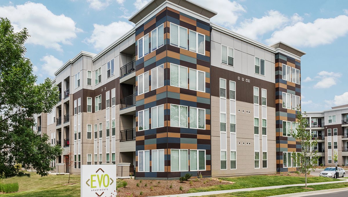 An exterior view of EVO apartments. from the corner of the building, which has facade of various brown and grey rectangles.
