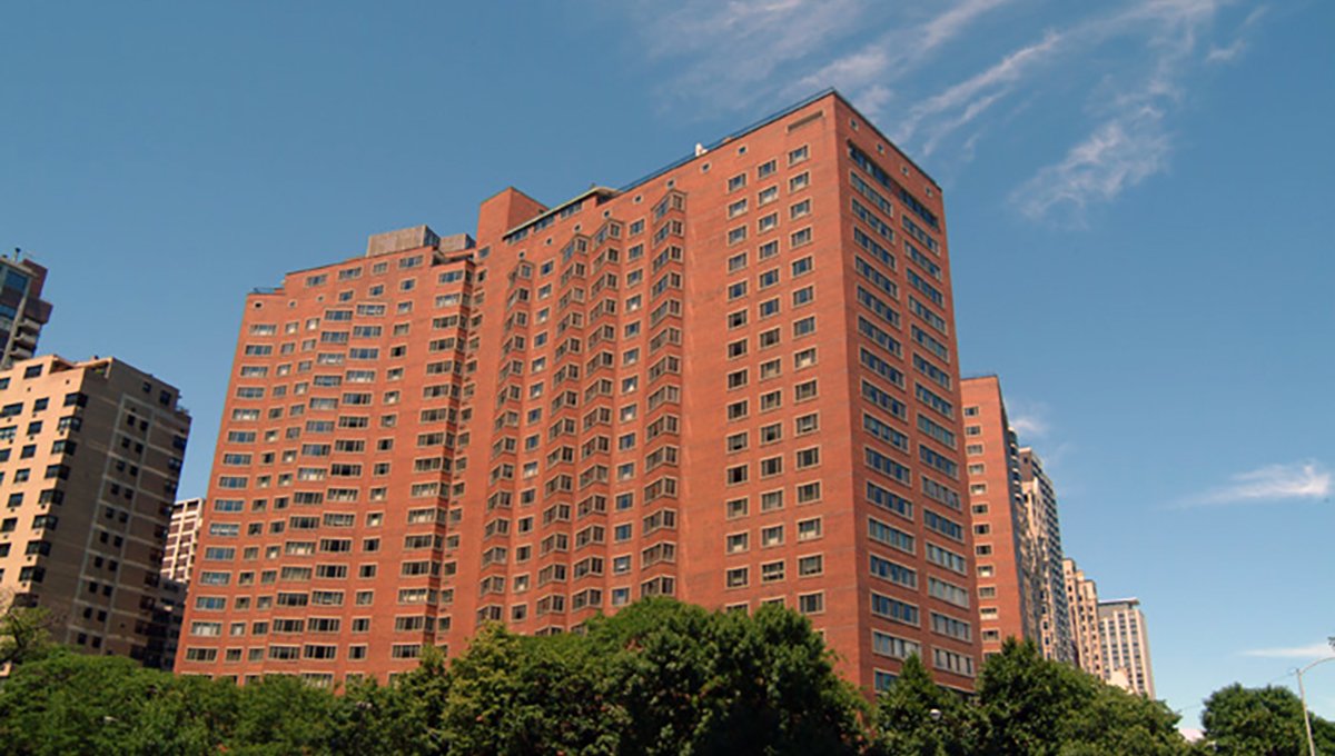 An exterior photograph of the red bricked 1350 North Lake Shore. Other buildings along Lake Shore Drive can be seen behind it.