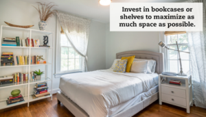 A bedroom with queen sized bed flanked by two curtained windows. A bookcase is filled on the left. A caption reads, "Invest in bookcases or shelves that extend several feet high to maximize as much space as possible."