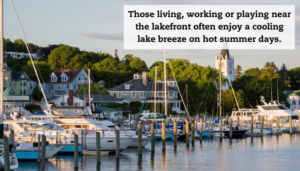 A lake harbor full of boats. A quote reads: "Those living, working, or playing near the lakefront often enjoy a cooling lake breeze on hot summer days."