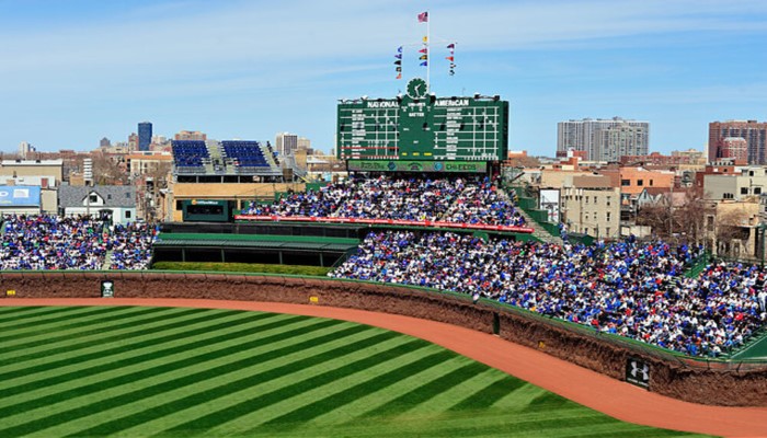 The outfield and scoreboard at Wrigley Field on sunny day.