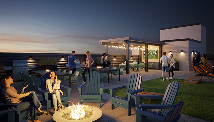 A rendering of the future rooftop deck at Wrigleyville Lofts. A couple of people sit around the fire pit on the left. To the right in the background, several more people watch a game on a big screen television.