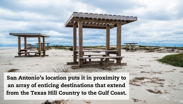 A sandy park with two picnic tables setup, both with built-in pergolas. A quote reads: "San Antonio’s location puts it in proximity to an array of enticing destinations that extend from the Texas Hill Country to the Gulf Coast."