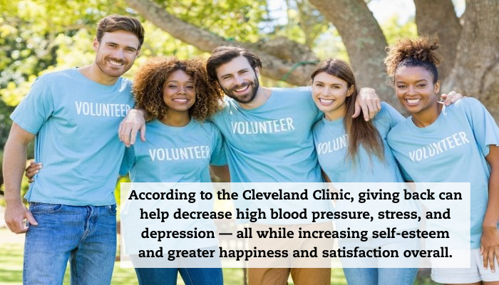 A group of friends smiles to the camera while all wearing blue shirts that say "Volunteer" on them. A quote reads: "According to the Cleveland Clinic, giving back can help decrease high blood pressure, stress, and depression — all while increasing self-esteem and greater happiness and satisfaction overall."