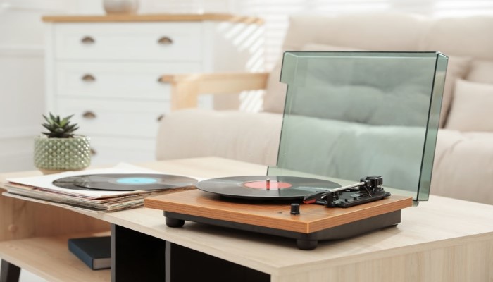 A turntable with vinyl record in a living room.