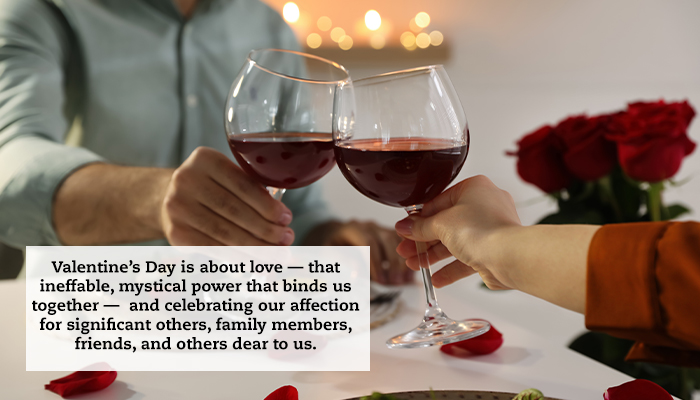 A close-up of a couple toasting with glasses of wine at a fancy restaurant. A quote reads: "Valentine’s Day is about love — that ineffable, mystical power that binds us together — and celebrating our affection for significant others, family members, friends, and others dear to us."