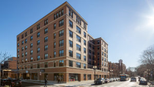 The exterior of Wrigleyville Lofts from across the street. It's a clear, sunny day.