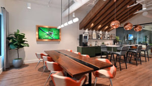 Looking across a large dining table with a coffee bar behind.
