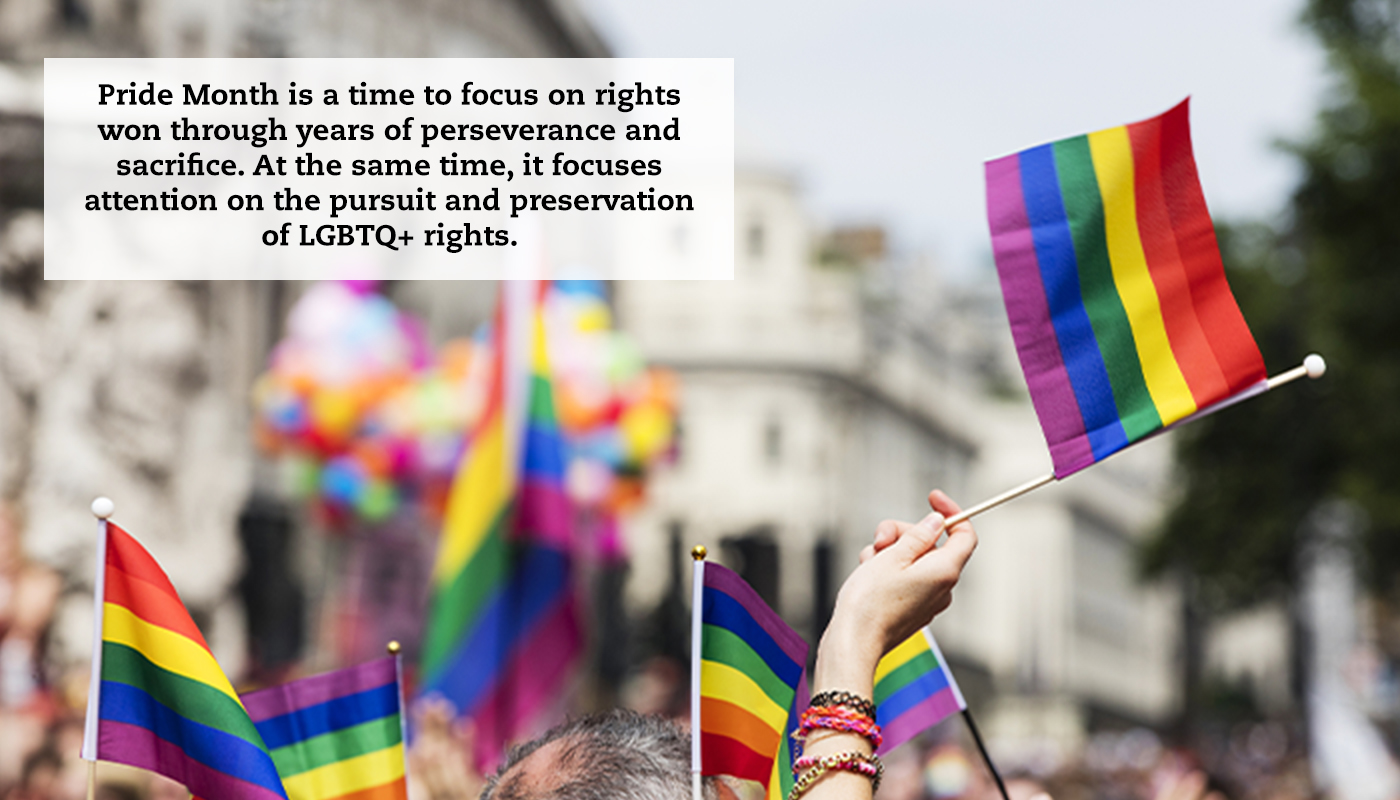 Hands are seen holding up the Pride Flag with a quote that reads: "Pride Month is a time to focus on rights won through years of perseverance and sacrifice. At the same time, it focuses attention on the pursuit and preservation of LGBTQ+ rights."