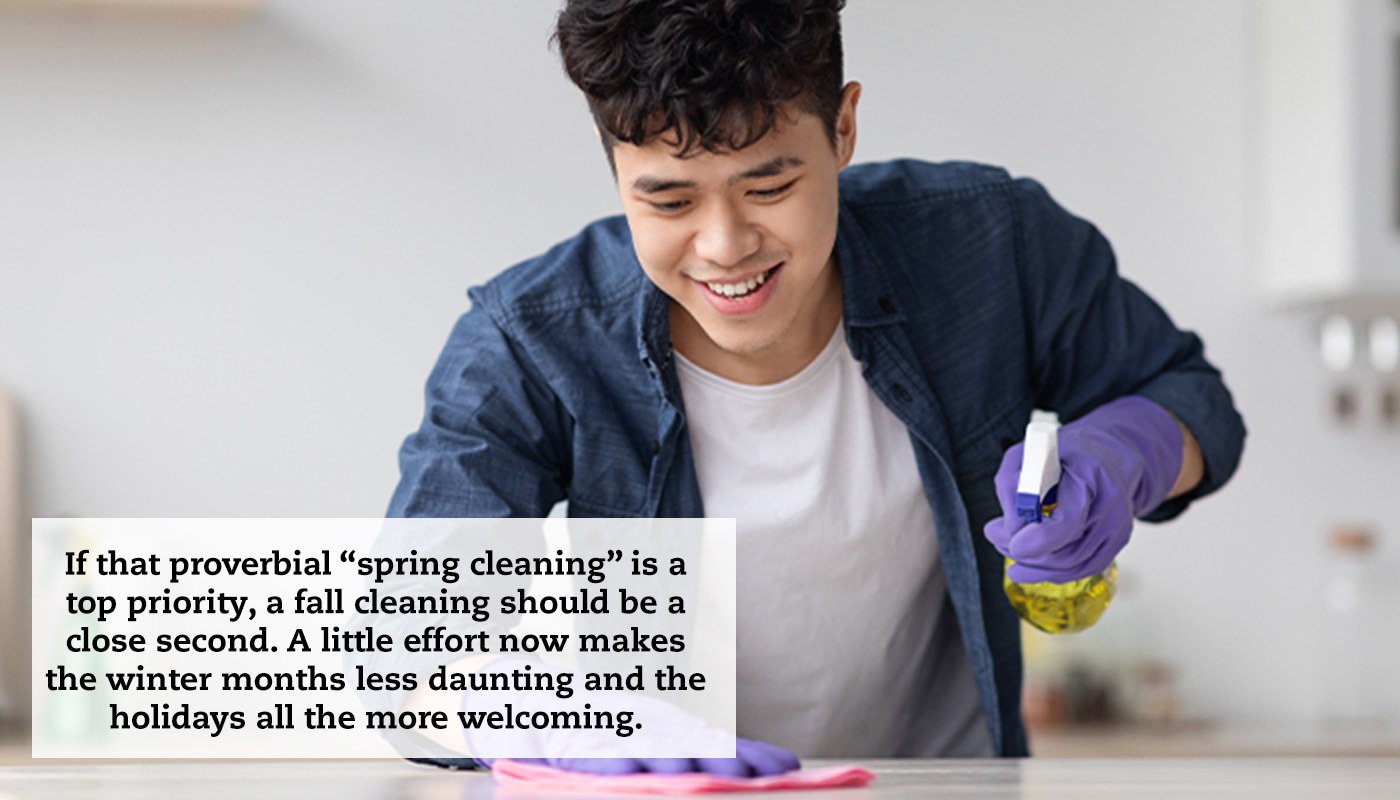A man wearing cleaning gloves sprays a cleaner onto his countertop and wipes it off. A quote reads: "If that proverbial “spring cleaning” is a top priority, a fall cleaning should be a close second. A little effort now makes the winter months less daunting and the holidays all the more welcoming."