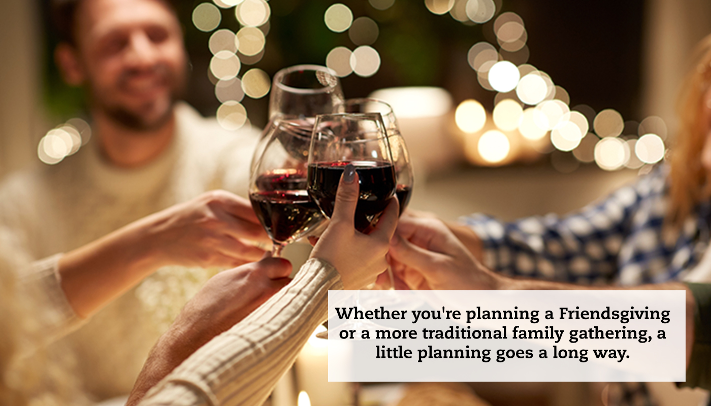 A close-up of wine glasses begin toasted together. Holiday lights can be seen in the background. A quote reads: "Whether you're planning a Friendsgiving or a more traditional family gathering, a little planning goes a long way."