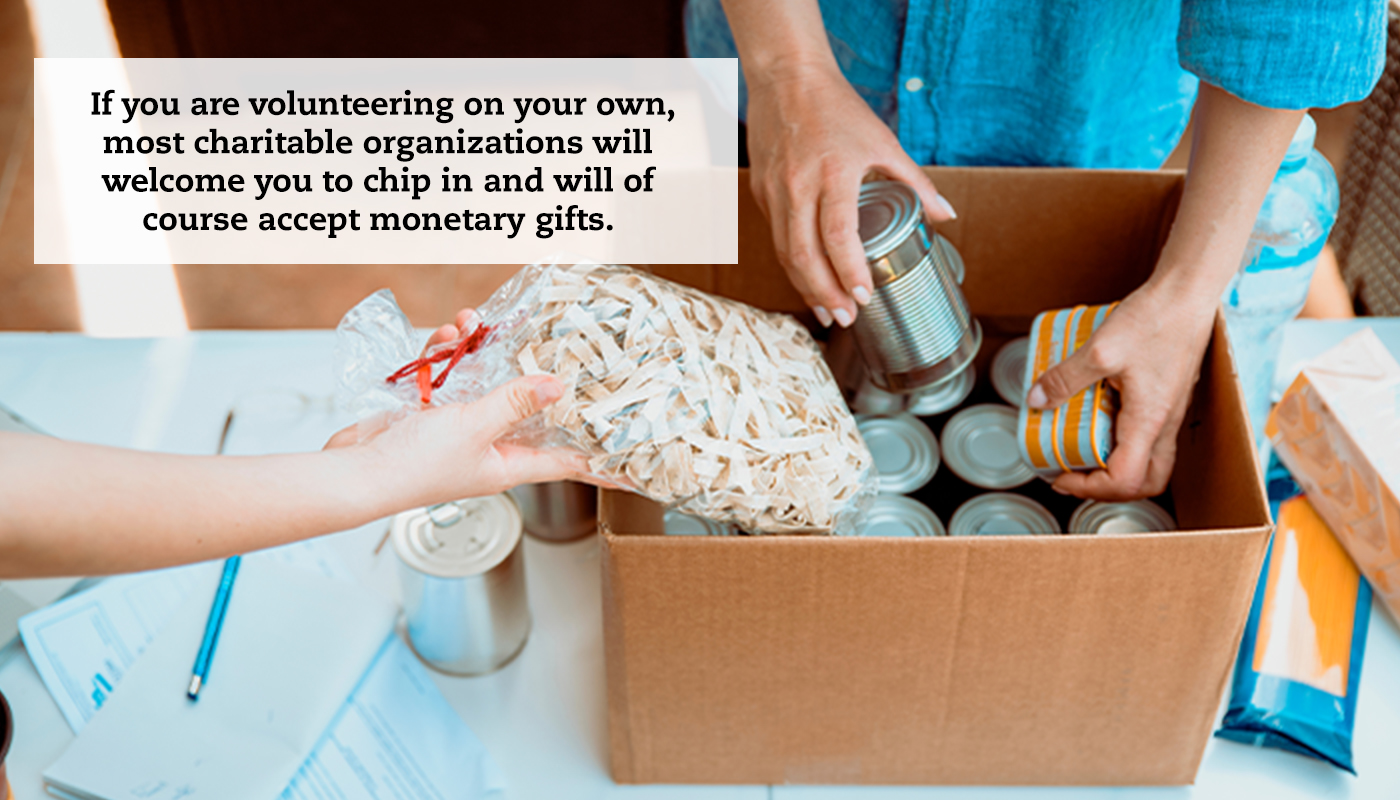 A close-up of a cardboard box being filled with packaged food. A quote reads: " If you are volunteering on your own, most charitable organizations will welcome you to chip in and will of course accept monetary gifts."
