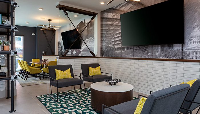 Lounge seating areas line the far wall with televisions mounted above.