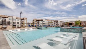 Looking across the pool at The Wright on a sunny day, the apartment buildings are seen in the background.