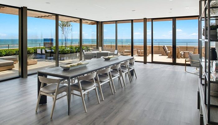 A dining room with large windows overlooking Lake Michigan.