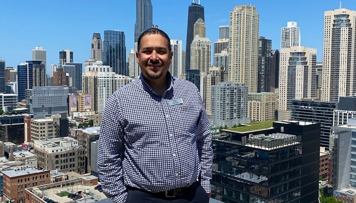 A man standing in front of the Chicago skyline.