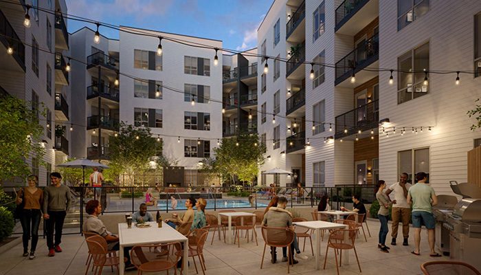 A modern apartment complex courtyard with string lights, people socializing at tables, and a swimming pool in the center. Patio furniture, plants, and multi-story buildings surround the area.