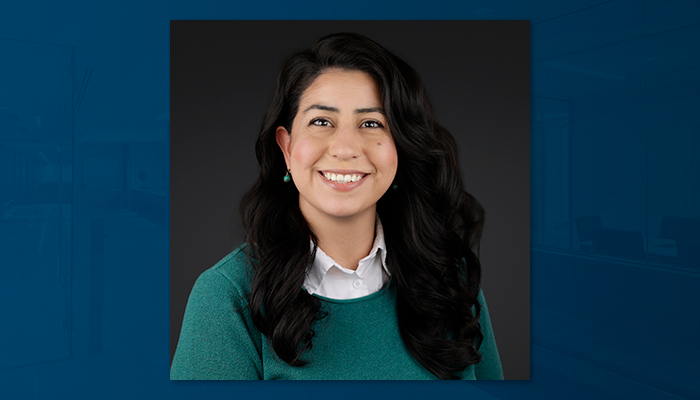 Professional headshot of Martha Gaitan-Manning, Draper and Kramer regional property manager, smiling against a dark background