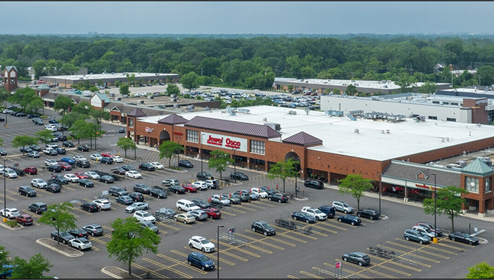 Aerial view of Village Crossing shopping center in Skokie, Illinois, featuring Jewel-Osco and surrounding retail storefronts and parking.